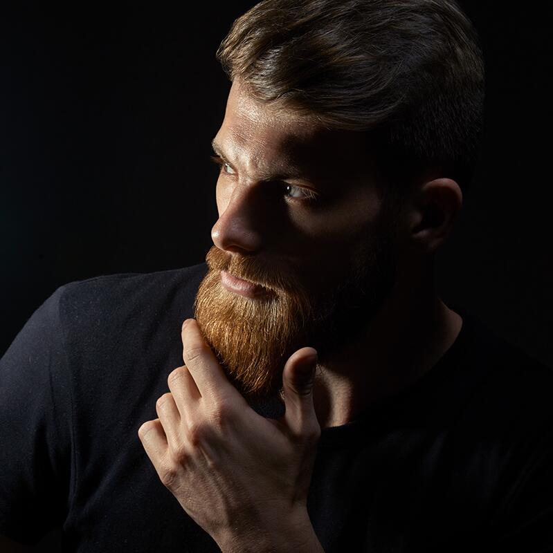 Hansome bearded man looking aside.